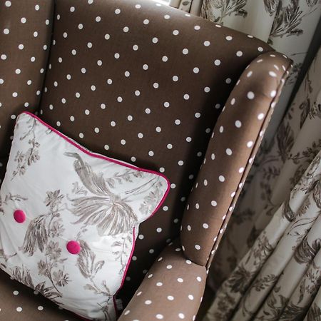 Grays Boutique B&B Bath Room photo A chair upholstered in a polka dot fabric